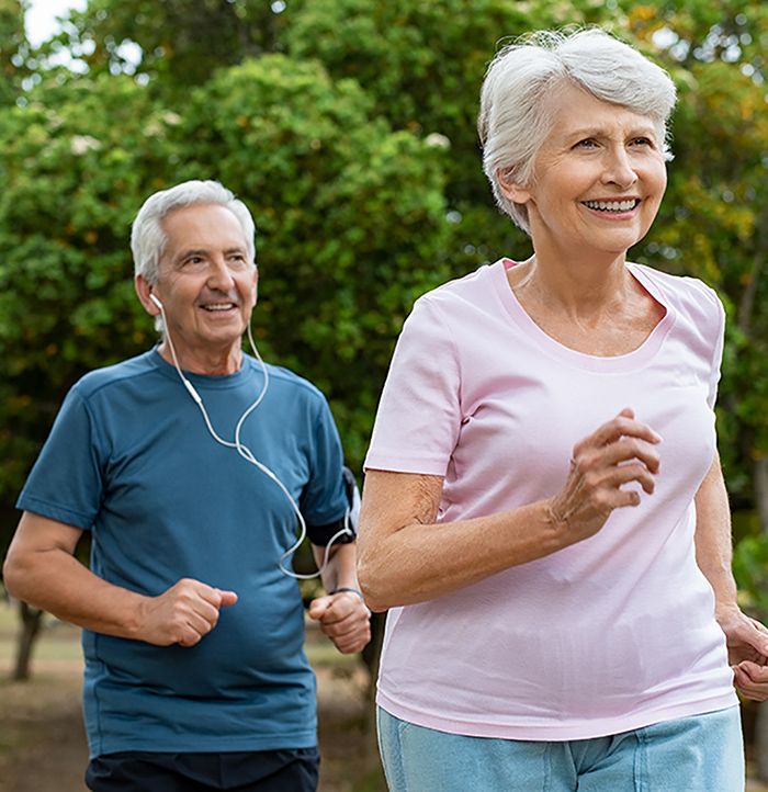 smiling older couple jogging