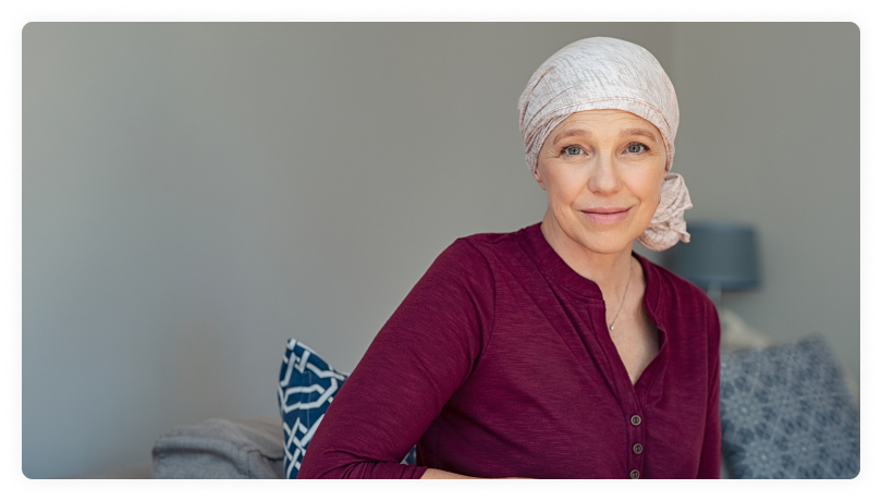 mature lady with scarf on head smiling at the camera